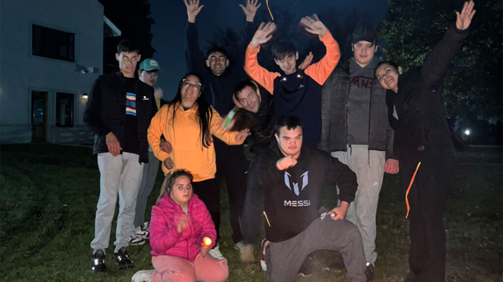 Jóvenes saludando en un campamento de Jugando con Amigos.